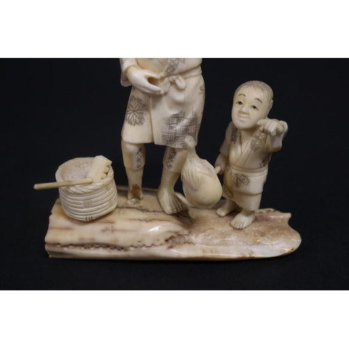 133 - Antique Japanese carved ivory figure group, farmer and boy, signed, approx 14cm H x 11cm W