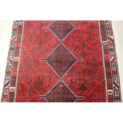 291 - Iranian hand knotted wool carpet, of red ground, approx 193cm x 142cm