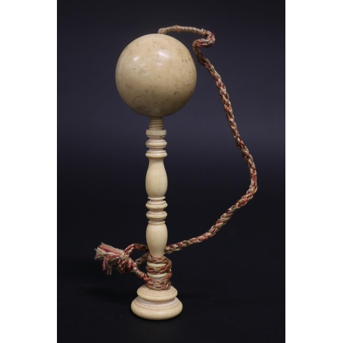 132 - Antique ivory ball on turned ivory stand, approx 17.5cm H