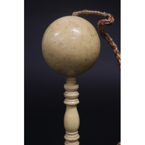 132 - Antique ivory ball on turned ivory stand, approx 17.5cm H