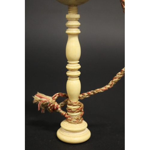 132 - Antique ivory ball on turned ivory stand, approx 17.5cm H