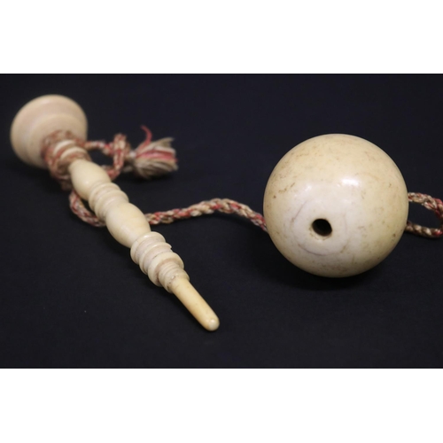 132 - Antique ivory ball on turned ivory stand, approx 17.5cm H