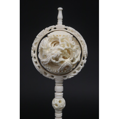 325 - Large Chinese carved ivory puzzle ball, carved with dragons, approx 29cm H