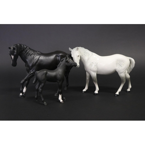 310 - Three medium sized Beswick horses, one in grey white the other back, approx 17.5cm H & 19cm H (3)