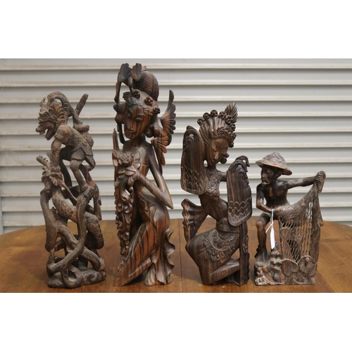 423 - Four carved hardwood South East Asian figures, approx 50cm H and shorter (4)