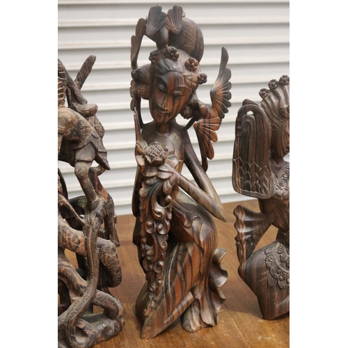 423 - Four carved hardwood South East Asian figures, approx 50cm H and shorter (4)