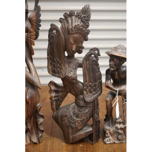 423 - Four carved hardwood South East Asian figures, approx 50cm H and shorter (4)