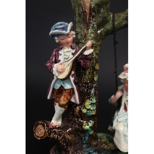 402 - Majolica courting couple on swing, approx 26cm H