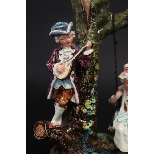 Majolica courting couple on swing, approx 26cm H