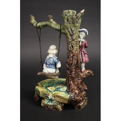 402 - Majolica courting couple on swing, approx 26cm H