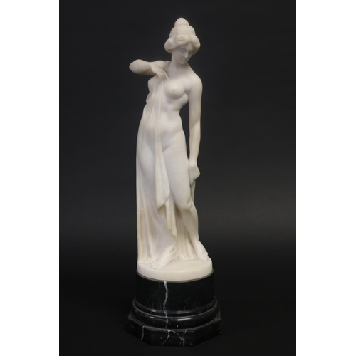 450 - Antique carved alabaster figure of a semi clad female, standing on a black marble base, unsigned. Ap... 