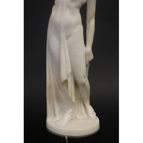 450 - Antique carved alabaster figure of a semi clad female, standing on a black marble base, unsigned. Ap... 