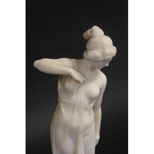 450 - Antique carved alabaster figure of a semi clad female, standing on a black marble base, unsigned. Ap... 