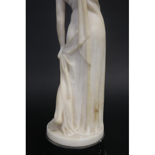 450 - Antique carved alabaster figure of a semi clad female, standing on a black marble base, unsigned. Ap... 