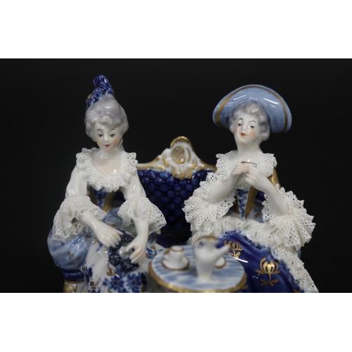 487 - German porcelain figure of two ladies having tea, approx 12cm H x 12cm W