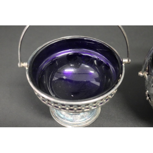 488 - Two EPNS & blue glass liner bowls with swing handles, along with a matched spoon, approx 10cm H excl... 
