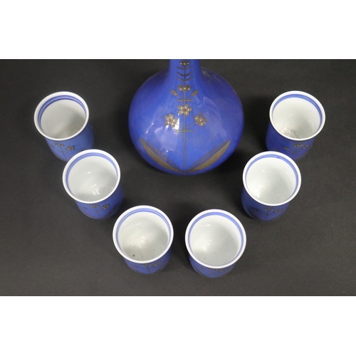 490 - Japanese porcelain sake bottle along with six matching sake cups, all of powder blue ground with gol... 