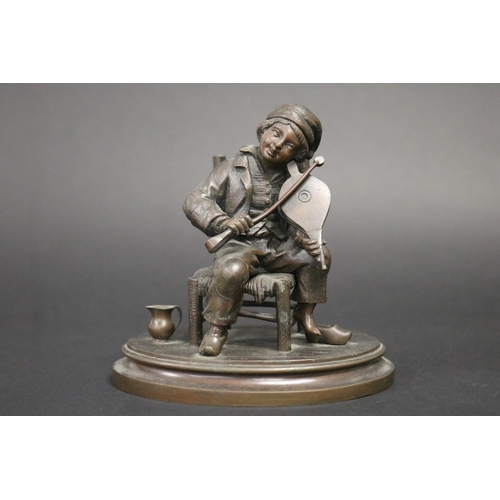 84 - Antique French or European bronze of a young boy playing bellows as a violin with coal nips, while s... 