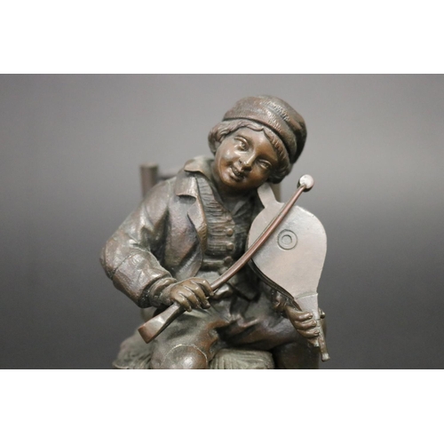 84 - Antique French or European bronze of a young boy playing bellows as a violin with coal nips, while s... 
