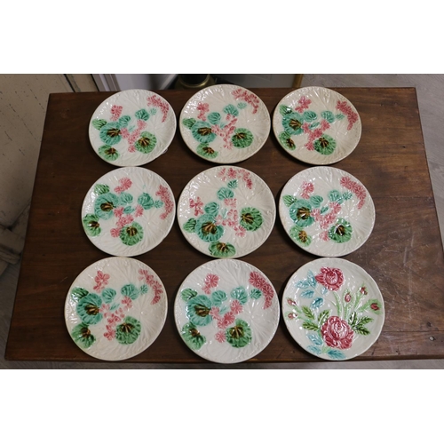32 - Set of eight antique French Majolica plates, floral decoration to each, unmarked, along with a match... 