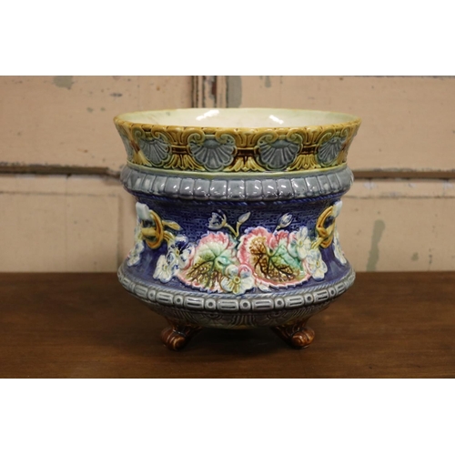57 - Antique French majolica jardiniere with floral motif standing on tri legs, approx 22cm H x 24cm Dia