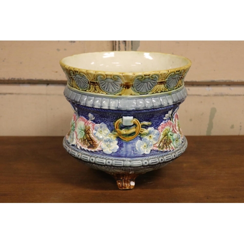 57 - Antique French majolica jardiniere with floral motif standing on tri legs, approx 22cm H x 24cm Dia