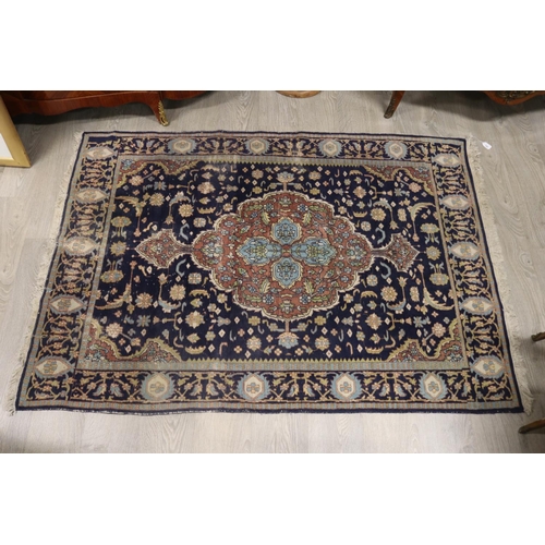 146 - Persian hand knotted wool carpet, royal blue ground with central medallion, approx 127cm x 190cm