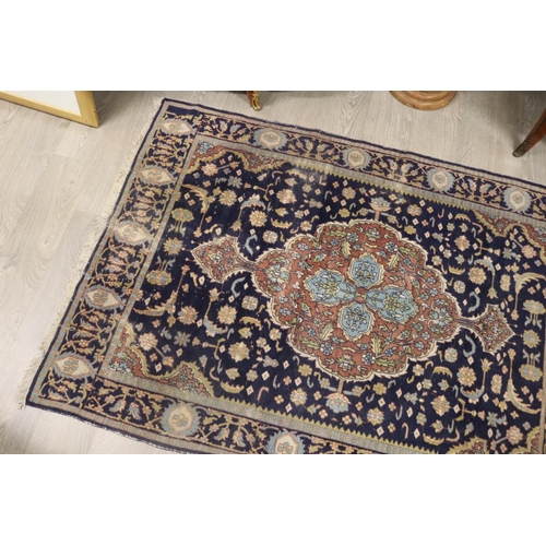 146 - Persian hand knotted wool carpet, royal blue ground with central medallion, approx 127cm x 190cm