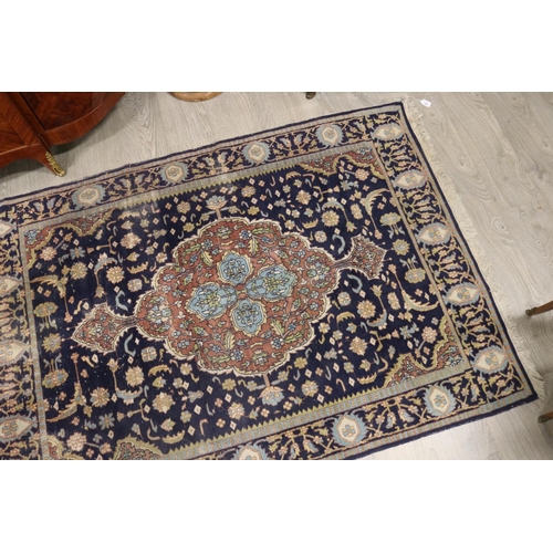 146 - Persian hand knotted wool carpet, royal blue ground with central medallion, approx 127cm x 190cm