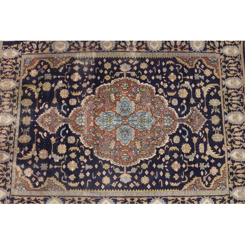 146 - Persian hand knotted wool carpet, royal blue ground with central medallion, approx 127cm x 190cm