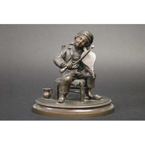 177 - Antique French or European bronze of a young boy playing bellows as a violin with coal nips, while s... 