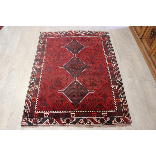 643 - Iranian hand knotted wool carpet, of red ground, approx 193cm x 142cm