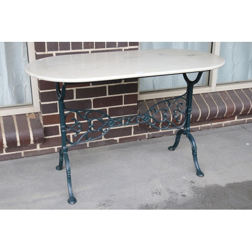 531 - Cast iron based Marble top garden table, approx 74cm H x 120cm W x 60cm D