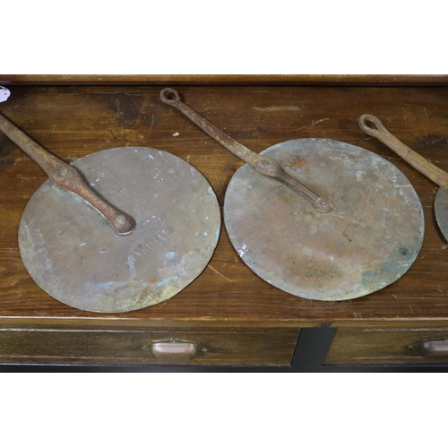 647 - Four antique French copper saucepan lids, approx 45cm L (including handle) and smaller (4)