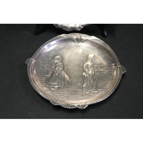 89 - Pair of antique WMF metal dishes, cast in relief with Dutch boys and girls, approx 12.5 cm dia (2)
