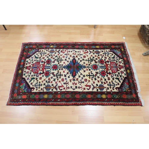 713 - Oriental wool carpet, hand woven with birds and animals, approx 102cm x 165cm