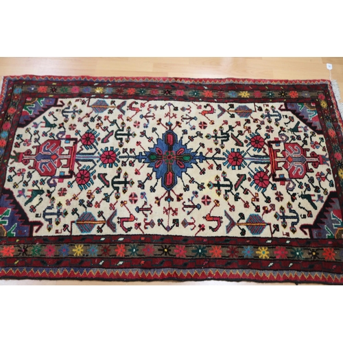 713 - Oriental wool carpet, hand woven with birds and animals, approx 102cm x 165cm