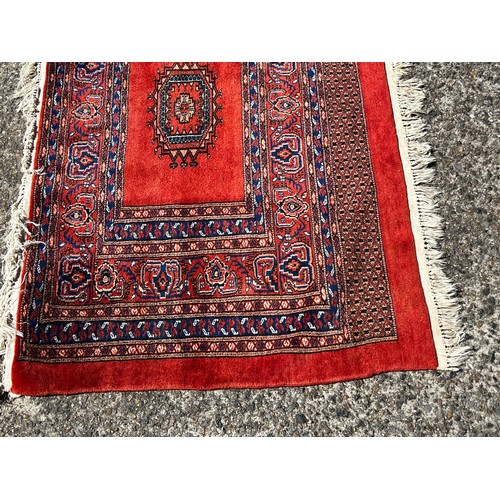 728 - Fine weave hand knotted wool carpet, red ground, approx 130 cm x 86 cm