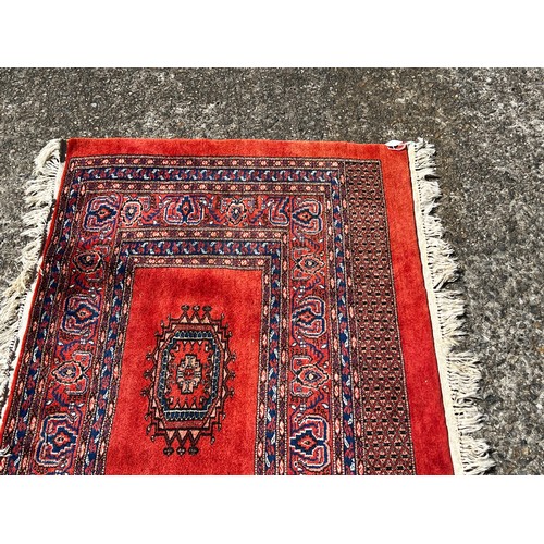 728 - Fine weave hand knotted wool carpet, red ground, approx 130 cm x 86 cm