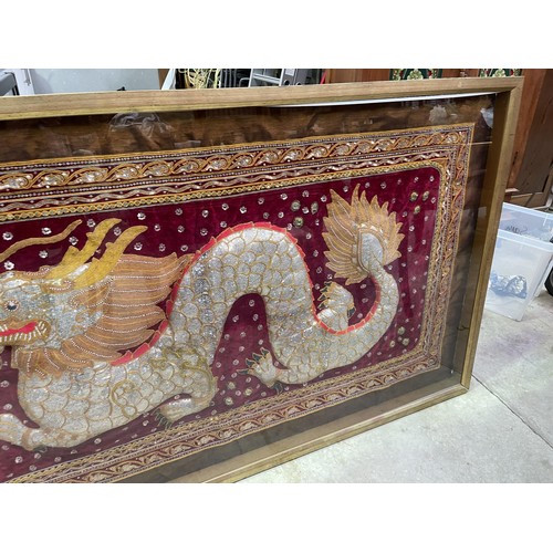 883 - Large Oriental shadow framed tapestry of a Dragon, approx 175 cm W, 101 cm H, 6 cm D.
