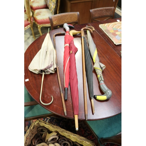 671 - Three bird bead umbrellas along with two silver mounted walking sticks, approx 91cm L & shorter (7)