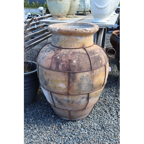 18 - Large antique French or Italian terracotta olive storage pot with iron strap work to the body, appro... 