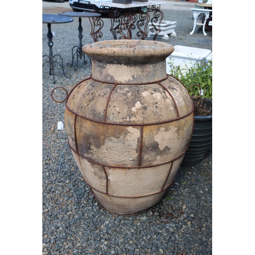 18 - Large antique French or Italian terracotta olive storage pot with iron strap work to the body, appro... 