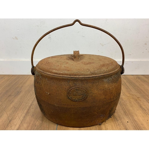 159 - Large cast iron pot and lid, 50cm x 33cm