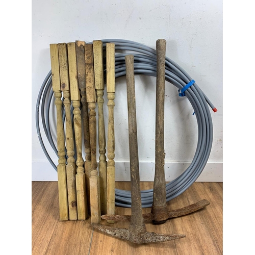 50 - 2 pick axes, wooden spindles and roll of pipe