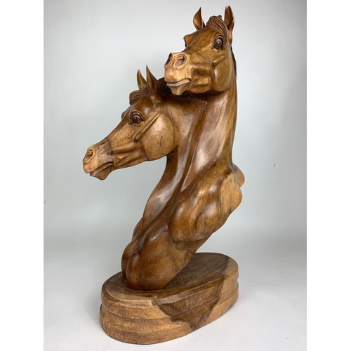 196 - Large carved wooden horse heads figure, 72cm