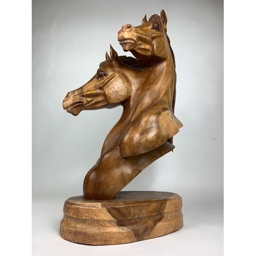 196 - Large carved wooden horse heads figure, 72cm