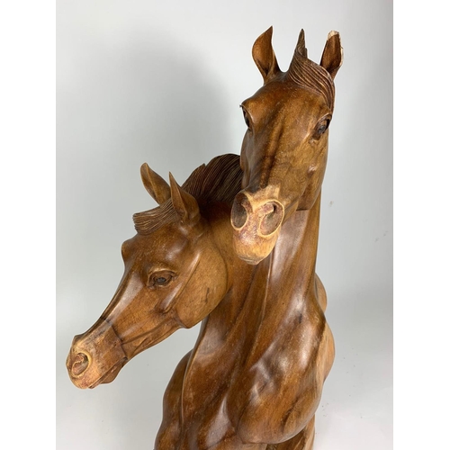 196 - Large carved wooden horse heads figure, 72cm