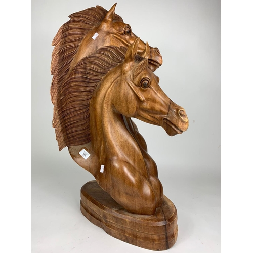 196 - Large carved wooden horse heads figure, 72cm