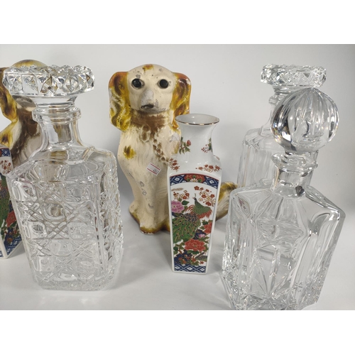 213 - Pair of pottery dogs, 5 crystal decanters and a pair of vases